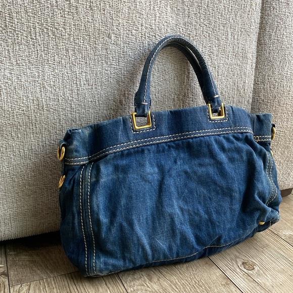 This is a Prada denim tote bag. No rips or tears, just minor wear from use. - Picture 3 of 9